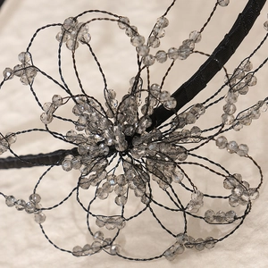 Handmade beaded bridal headband with crystal flowers and delicate black wire petals