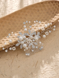 Dettaglio del pettine da sposa con perle e strass su un piatto decorativo in ceramica
