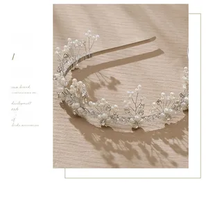 Detail of bridal headband with intricate silver wire weaving, pearls and rhinestones