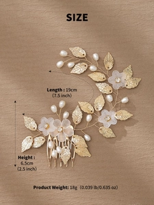 Macro detail of handmade gold bridal hair comb with white matte flowers and pearls