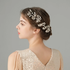 Detailed view of silver flower hair pin with sparkling crystals in a bridal updo