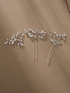 Macro view of bridal hair pin set with crystals and handmade silver floral wire work