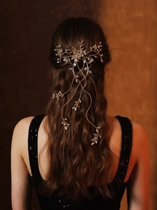 Detailed view of bridal hair comb with gold leaves crystals and long tassel cascades