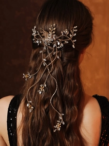 Detail of bridal hair comb with cascading crystal tassels and floral rhinestone accents