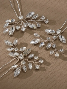 Detail of silver bridal hair pins with intricate pearl and crystal floral design