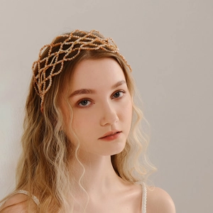 Detail of luxury handmade champagne beaded headband with intricate mesh crystal design