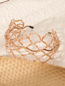 Detail of multi-layer hand-beaded crystal mesh headband in soft apricot tones