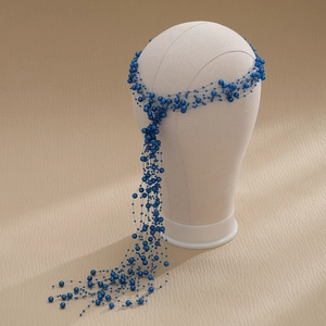 Detail of blue pearl tassel hairband with woven net structure for bridal wedding