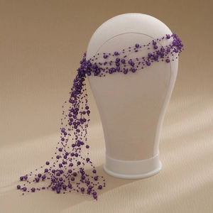 Detailed view of dark purple pearl beaded headband with elegant long tassels for weddings