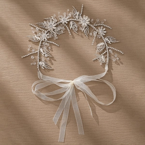 Elegant bridal floral headband with crystals and pearls for wedding hairstyles