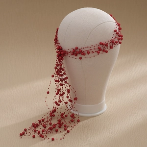 Detail of red beaded tassel headband with cascading strands for wedding hairstyles