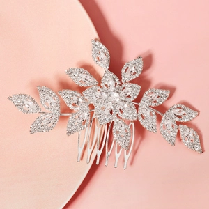 Close-up of silver bridal hair comb with cubic zirconia flowers and leaf design