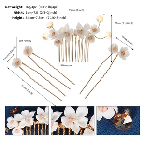 Detailed view of floral bridal hair comb and pins set with sizes and ivory soft pottery flowers