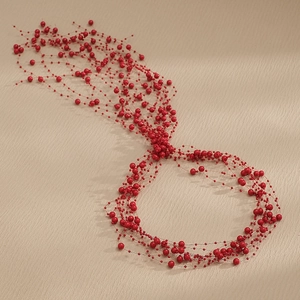 Macro detail of flexible handmade red pearl bridal hair vine with shimmering bead strands