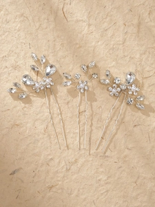 Macro detail of handmade bridal hair pins with silver wire, pearls, and clear crystals