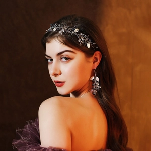 Detailed macro of handmade silver bridal headband and earrings with blue crystals