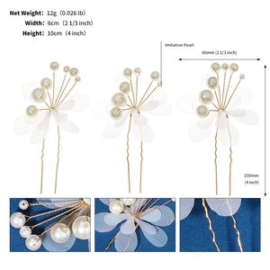 Detail view of handmade gold wire hair pins with white pearls and mesh petals