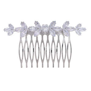 Macro detail of silver bridal hair comb with cubic zirconia floral leaf patterns