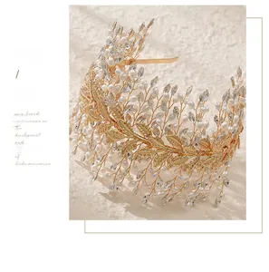 Detailed macro view of the gold bridal headband with rhinestones, pearls and leaf elements
