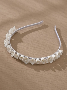 Detailed macro shot of bridal headband featuring white ceramic lily of the valley flowers