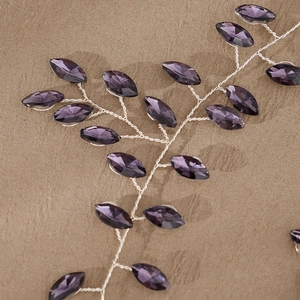 Detail of purple marquise crystal bridal hairpiece with hand-woven silver wire vines