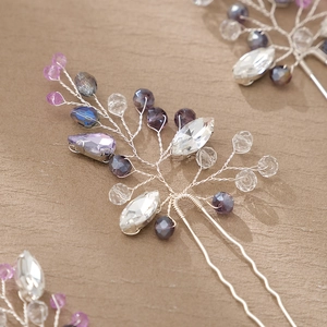 Macro detail of handmade silver hair pin with purple crystals and pearl beads for wedding
