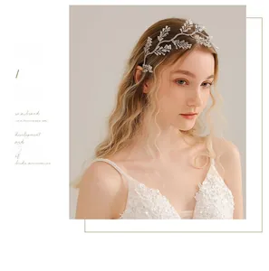 Detail of silver bridal headband featuring clear crystals and white faux pearls on vine