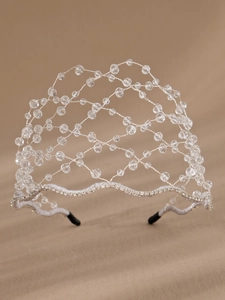 Close-up of handmade crystal beaded bridal headband with intricate silver wire weaving