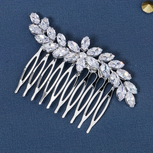 Detail of silver bridal hair comb with marquise-cut zircon floral and leaf design