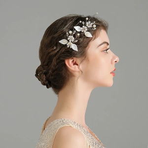 Detail of white flower bridal hair pins with pearls and crystals on elegant updo