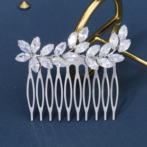 Detailed macro shot of bridal hair comb with leaf-shaped zircon stones and ten-tooth metal base