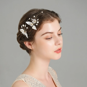 Detailed view of handmade pearl flower hair pins for bridal styling and wedding accessories