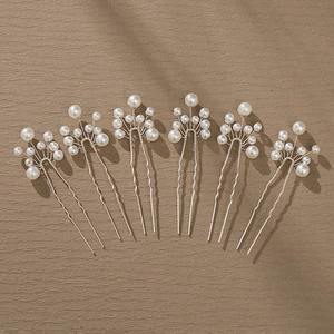 Detail of 6-piece bridal hair pin set with white pearls and silver leaf branch design