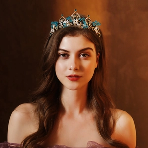 Detail of baroque bridal crown featuring gold alloy base with blue crystals and pearls