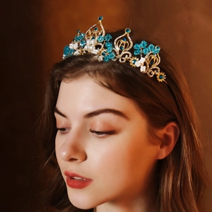 Close-up of golden bridal crown with blue crystals and beads on a model for wedding style