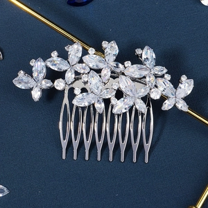 Detailed view of silver bridal hair comb featuring floral zirconia leaf arrangements
