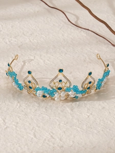 Detail view of baroque bridal crown with blue crystals and handmade white pearls