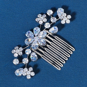 Detailed view of bridal hair comb with cubic zirconia flowers and silver metal vine leaves