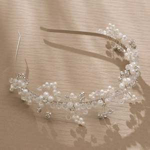 Exquisite bridal headband with white pearls and clear crystals on a silver metal frame