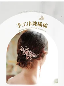 Detail view of handmade bridal hair comb with pearls and rhinestones on a rose gold base
