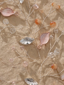 Macro detail of handmade bridal headband with crystal beads and silver wire leaves