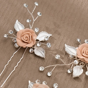 Detailed view of handmade bridal hair pin with pink roses, pearls and crystals