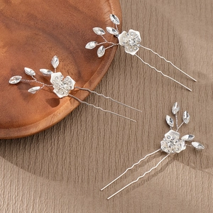 Detail of silver floral hair pins with sparkling crystals and rhinestones for bridal styling