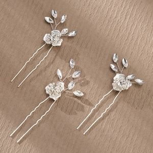Detailed view of 3pcs silver bridal hair pins with pearls and crystal floral elements