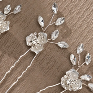 Detail of handmade silver floral hair pin with sparkling rhinestones and crystal beads
