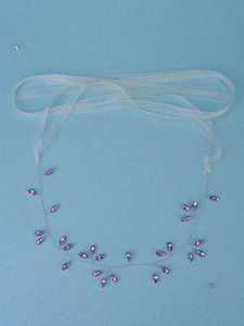 Detail of silver wire bridal hair vine with purple crystals and white chiffon ribbons