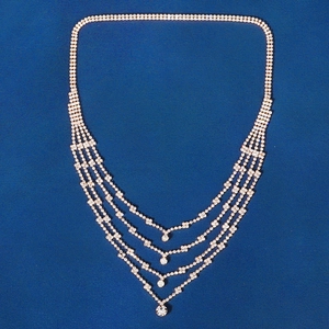 Detailed view of layered bridal forehead chain with gold chains and sparkling rhinestones