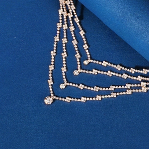 Detail of multi-layer gold bridal forehead chain with sparkling rhinestone drapes