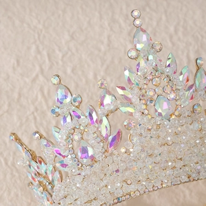 Close-up detail of luxury gold bridal crown with AB crystals and teardrop rhinestones
