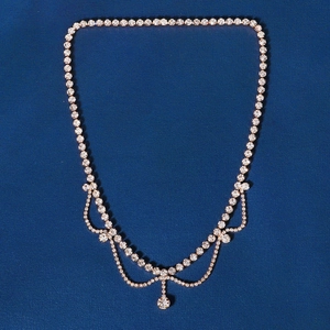 Detailed view of bridal rhinestone head chain with layered gold finish and teardrop pendant